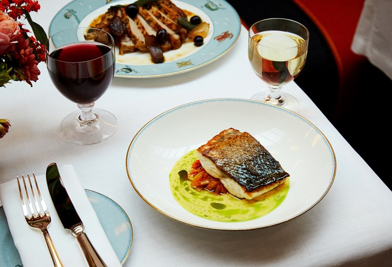 A Sea Bass Fillet in a green pesto sauce