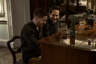 A still from the film "Power Ballad": the image displays two men sitting at a piano