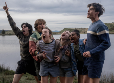 A film still from the film Sunny Dancer in it you see the main cast, Bella Ramsey, Daniel Quinn-Toye,Ruby Stokes, Earl Cave, Conrad Khan, Jasmine Elcock cheering and celebrating