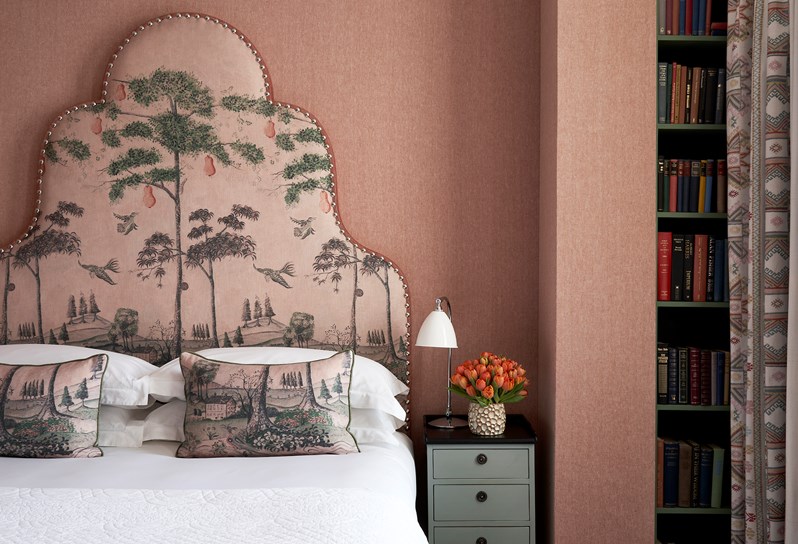 A close up shot bedroom with a gorgeous tall tree headboard at Charlotte Street Hotel