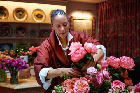 Shot of floral designer Tawana Schlegel arranging some bright pink flowers 