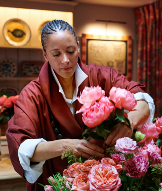 Shot of floral designer Tawana Schlegel arranging some bright pink flowers 