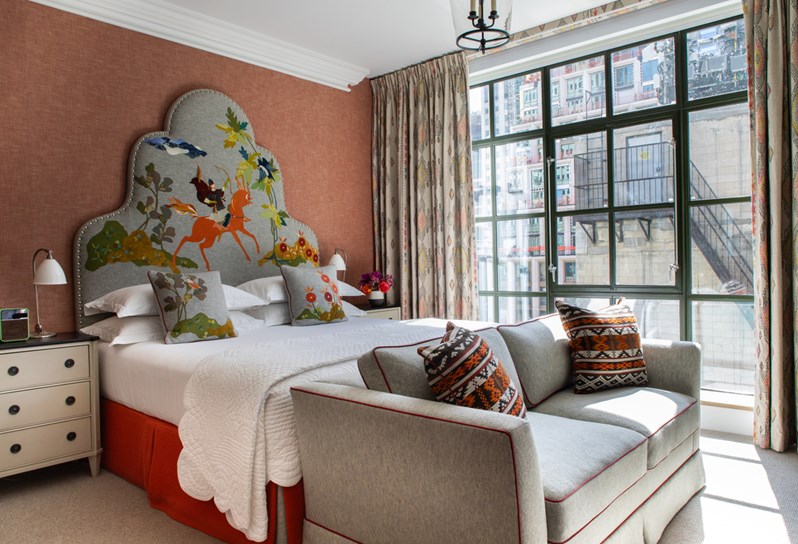 Diagonal bedroom shot of the bed in room 1508, a Junior Terrace Suite at The Whitby Hotel.