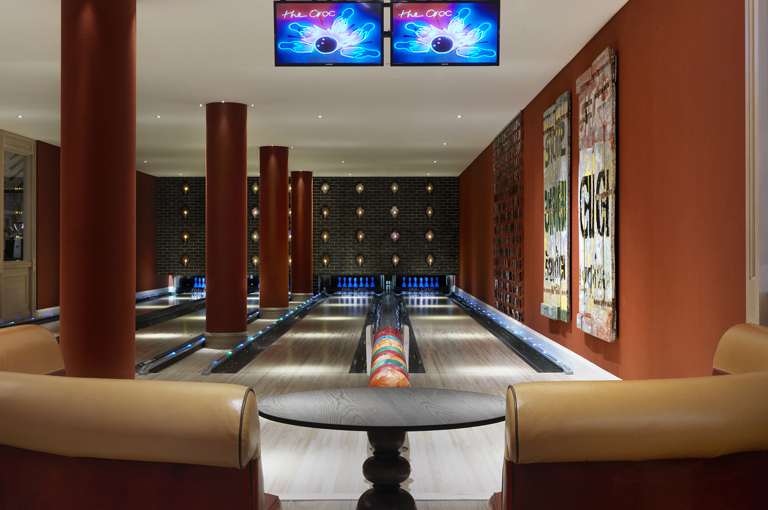Close shot of a seating area and Croc Bowling Alley at Ham Yard Hotel