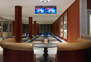 Close shot of a seating area and Croc Bowling Alley at Ham Yard Hotel