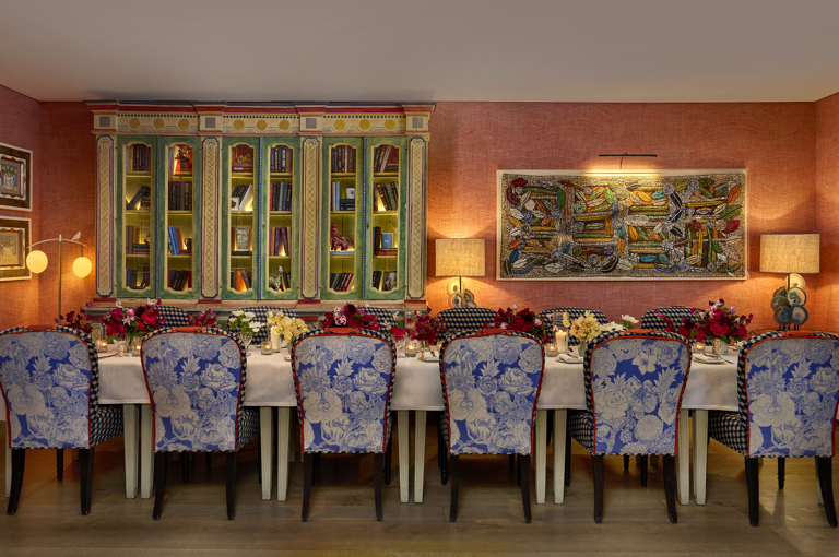  A wide angle image of the the drawing room at Warren Street Hotel: the table is set up for private dining and the image focuses on the patterned chairs
