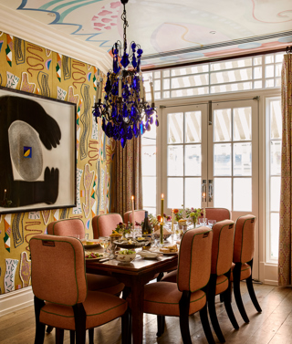 A portrait shot of the Dora Carrington event space at Charlotte Street Hotel: the table is set up for private dining for eight people with lunch dishes being shared