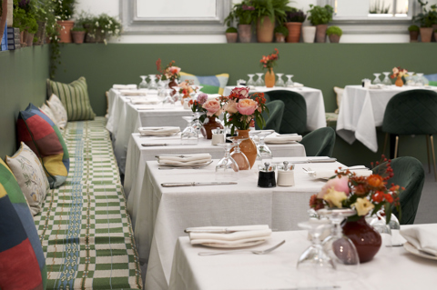 A row of tables and banquettes in Ham Yard at Frieze Masters designed by Kit Kemp Design Studio