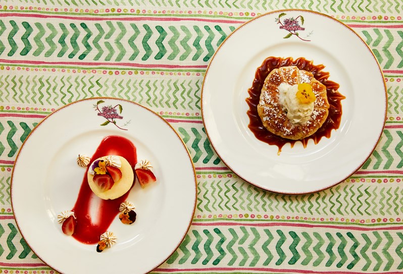 Close up shot of a cheesecake and the tart on a plate from the desserts menu, at Crosby Street Hotel.