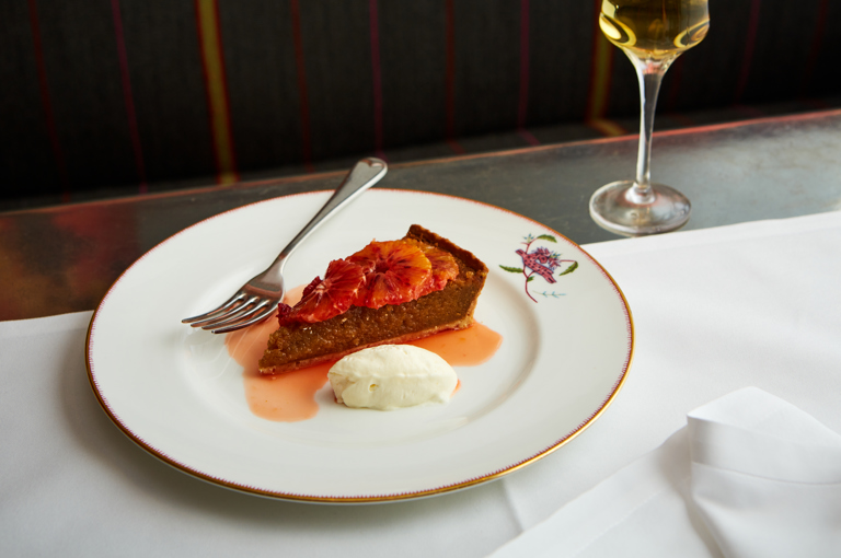 Close up shot of a treacle tart with ice cream at Refuel