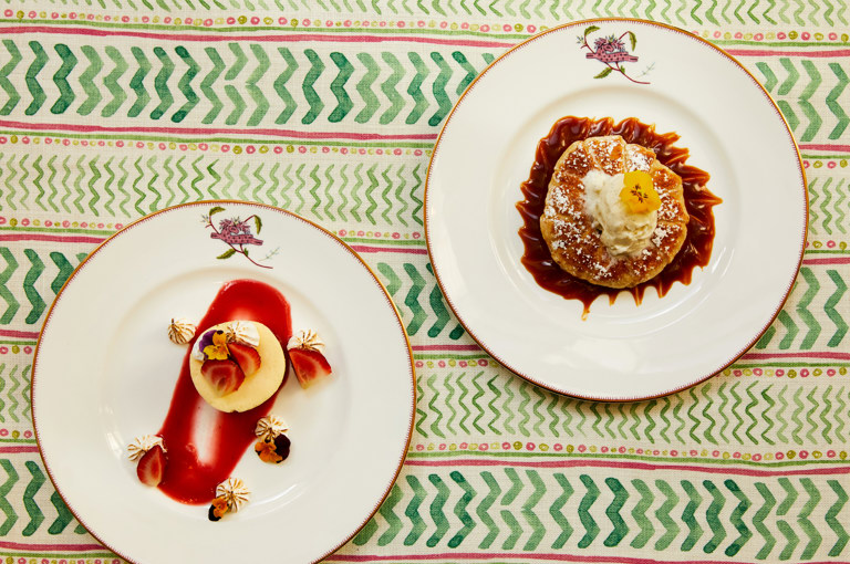 Close up shot of a cheesecake and the tart on a plate from the desserts menu, at Crosby Street Hotel.