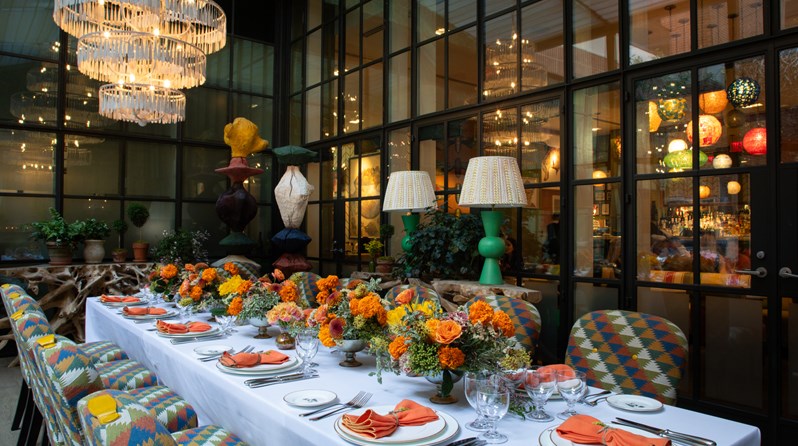 Image of a long table set up for lunch in The Orangery at Crosby Street Hotel.