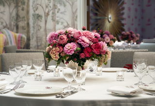 Close shot of a round dining table in the Prince private events room at Crosby Street Hotel