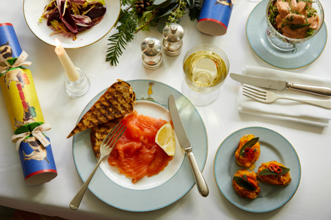 Close shot of festive dining set-up with white wine on Sailor's Farewell bespoke crockery