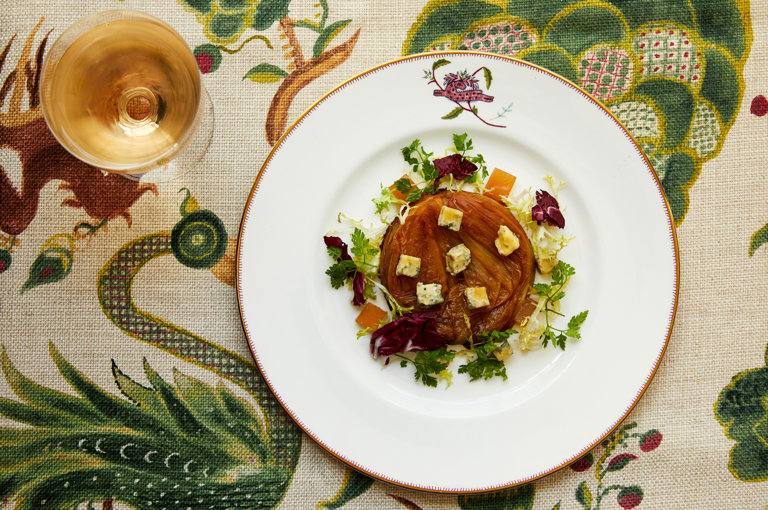 An image of  an onion tart on a plate, at Refuel, Soho Hotel. 