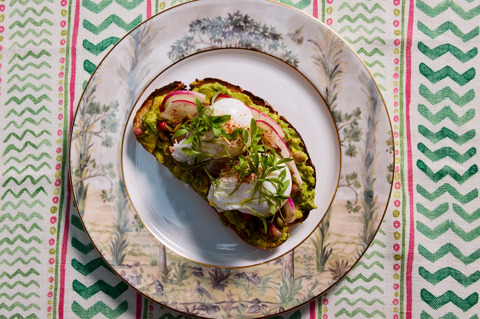 A plate of avocado on toast on a patterned tablecloth at Warren Street Bar