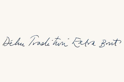 Handwritten script saying Dehu Tradition Extra Brut