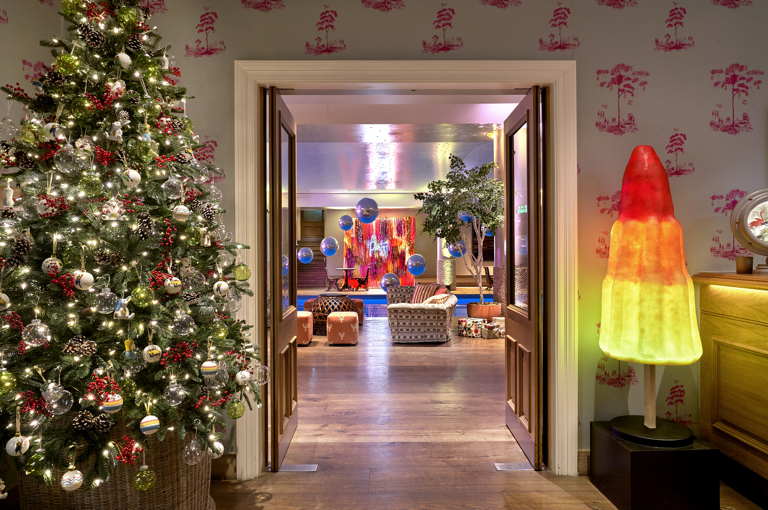 Shot of a Christmas Tree in the Events Lobby at Haymarket Hotel. In the back of the image, we can see the swimming pool.