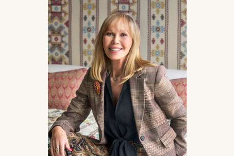 This is an image of Kit Kemp, selected by Kit Kemp, to promote her event 'An Evening with Kit Kemp'. This has been altered using Canva to add a background the same as the website so it can be used as a landscape.