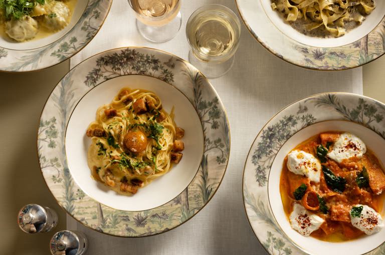 A wide angle shot of a selection of lunch dishes from the A La Carte menu including black truffle tagliatelle paired with white wine