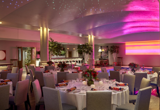 Round dining tables set up in the Swimming pool private events room at Haymarket Hotel