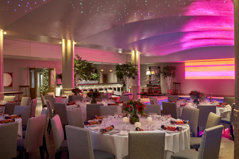 Round dining tables set up in the Swimming pool private events room at Haymarket Hotel