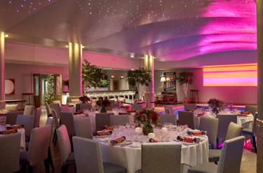 Round dining tables set up in the Swimming pool private events room at Haymarket Hotel