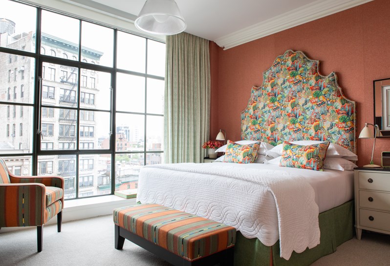 A diagonal image of the bed in The Deluxe Room Top Floor, 803, at Crosby Street Hotel.