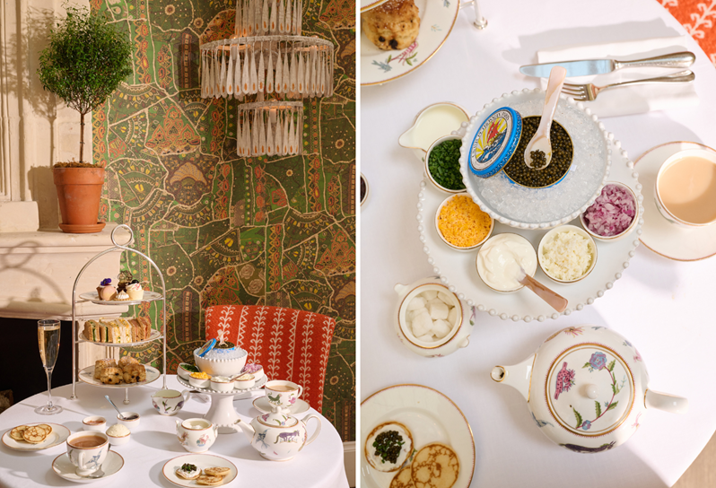 A table set for afternoon tea with cake stand, a teapot and tea cups and a plate of caviar