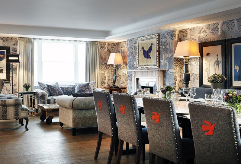 Nash event room beautifully set for private dining on one long table, with comfortable chairs, beautiful flower arrangements and Kit Kemp's own bone china range for Wedgwood.