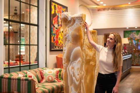 Willow Kemp stands next to a sculpture at The Whitby Hotel