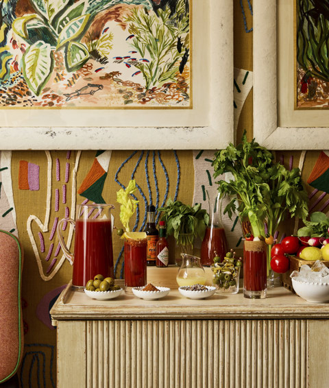 A portrait shot of the Bloody Mary bar in the Dora Carrington Room at Charlotte Street Hotel: the bar is set up with a selection of garnishes, ice and fresh fruit