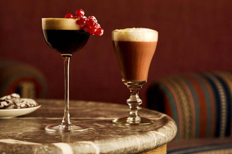 Two festive cocktails at Brumus. An espresso martini with red berries and a hot chocolate cocktail.