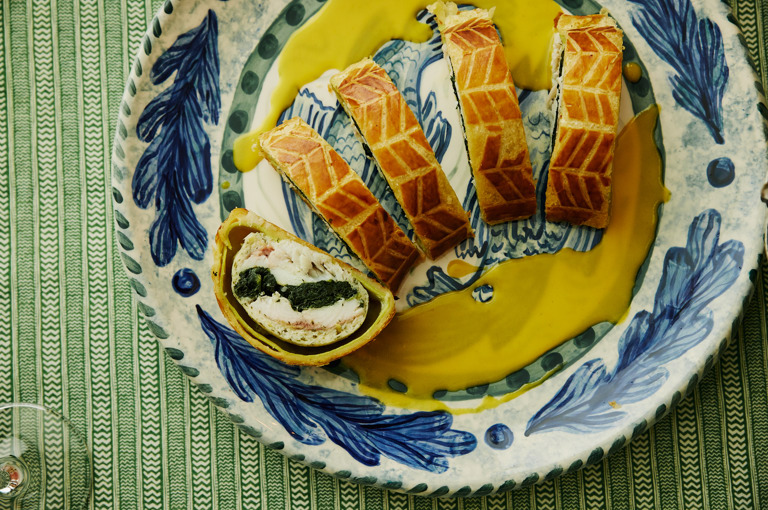 A close up image of the Sea bass en croûte, spinach and Champagne beurre blanc on Sasha Compton crockery to promote the Refuel, Christmas Eve menu at Soho Hotel.  