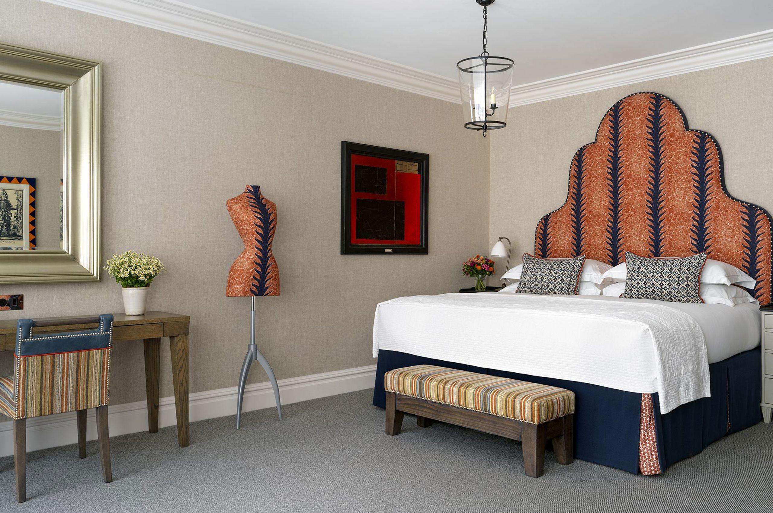 Luxury hotel bedroom with patterned headboard and elegant furnishings