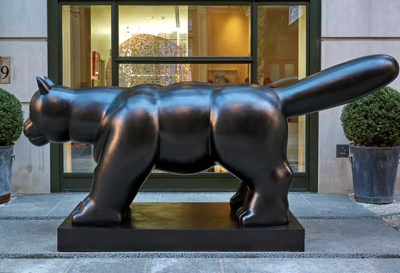 A large black 12ft bronze sculpture of a cat