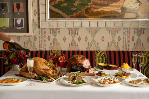 This a landscape image of a festive dining scene at The Whitby Bar, The Whitby Hotel, featuring different dishes from the festive menu including a seasonal pasta dish and a traditional roast dinner served on Sailors Fairwell crockery.