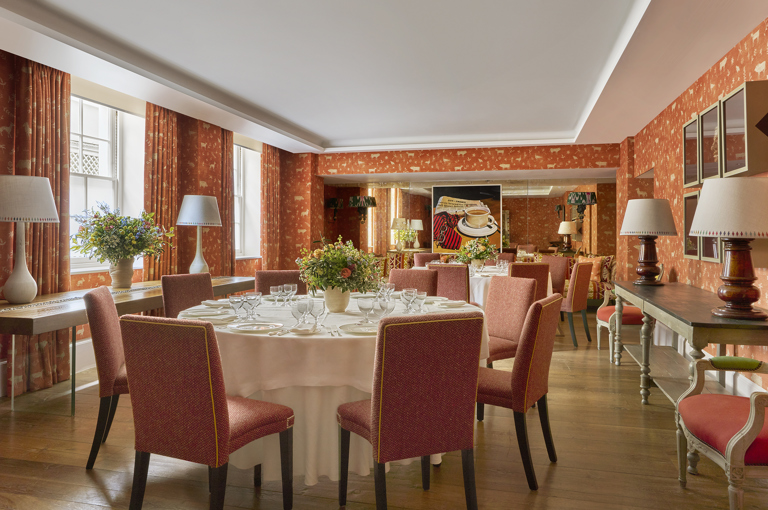 Day shot of a two round tables set up for private dining in the Rocklin Room at Haymarket Hotel