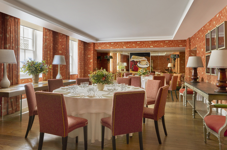 Day shot of a two round tables set up for private dining in the Rocklin Room at Haymarket Hotel