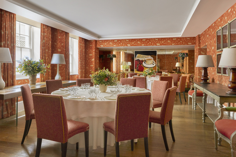 Day shot of a two round tables set up for private dining in the Rocklin Room at Haymarket Hotel