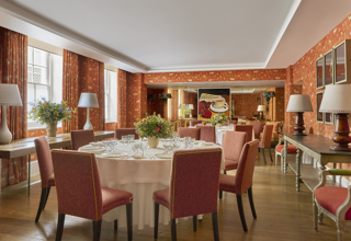 Day shot of a two round tables set up for private dining in the Rocklin Room at Haymarket Hotel