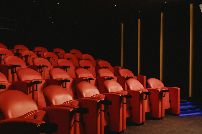 Diagonal shot across the red seating in the screening room at Covent Garden Hotel