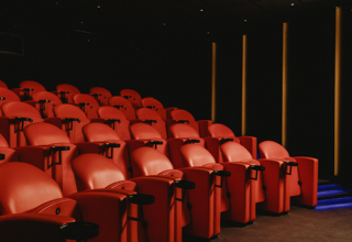 Diagonal shot across the red seating in the screening room at Covent Garden Hotel