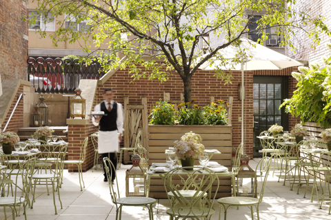 Front shot of tables in the Terrace at Crosby Street Hotel