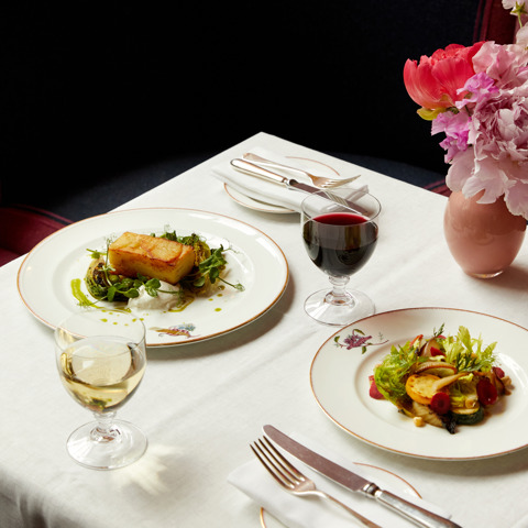 Main courses of roast potato and vegetable salad on plates at Brumus
