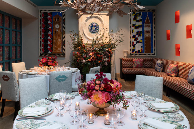 A close up shot of  round wooden table with four chairs in The Orangery at Warren Street Hotel.