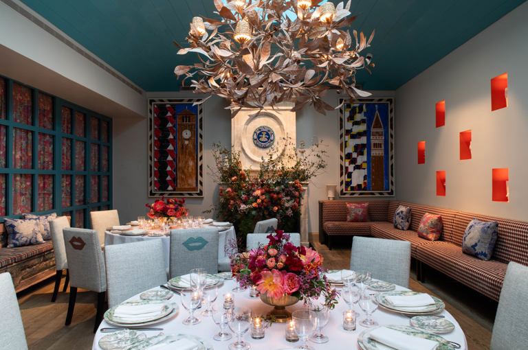 A close up shot of  round wooden table with four chairs in The Orangery at Warren Street Hotel.