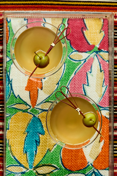 A close up image of two cocktails on a bright colourful tray.