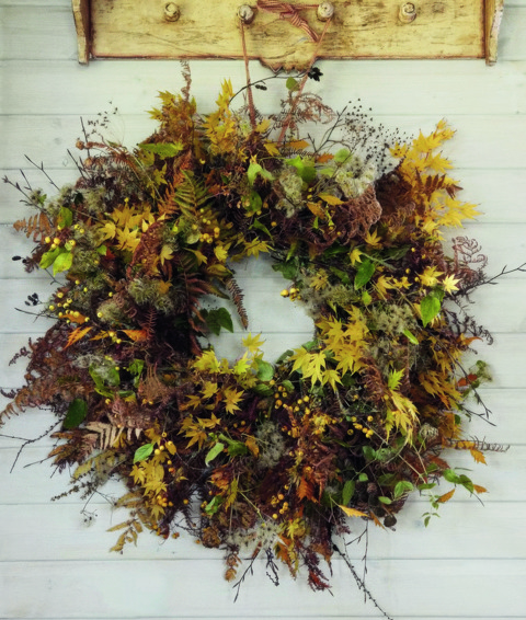 An image to promote Harriet Thystlethwaytes new book 'A country style: living and creating with nature through the seasons' the image shows a wreath of leaves Harriets garden.