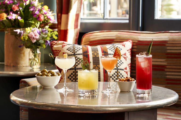 Wide shot of cocktails and bar snacks at Oscar